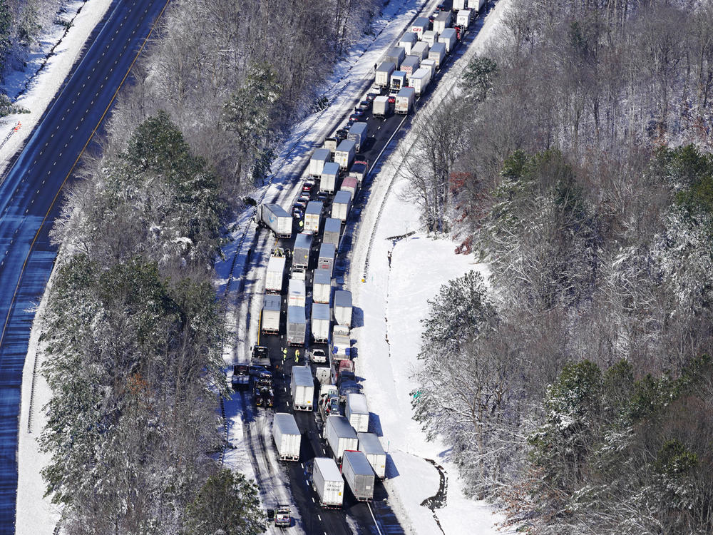 Drivers wait for the traffic to be cleared as cars and trucks are stranded on sections of Interstate 95 on mid-day Tuesday in Carmel Church, Va.