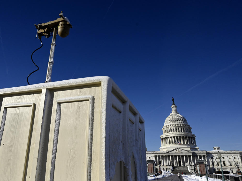Newly installed surveillance cameras are positioned near the U.S. Capitol on Tuesday.