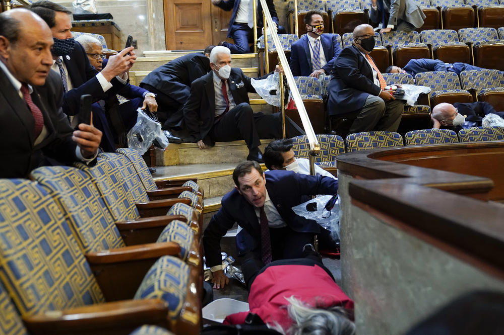 Representatives, staffers and observers shelter in place in the House gallery as rioters try to break into the chamber.