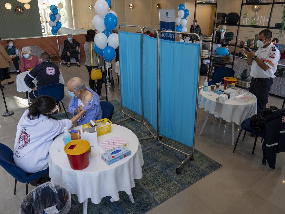 A man receives his fourth dose of the coronavirus vaccine in a private nursing home in Petah Tikva, Israel, on Tuesday.