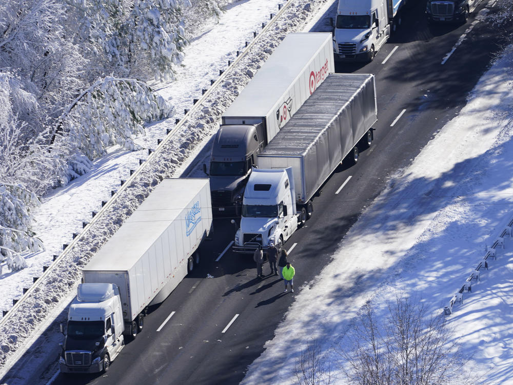 Drivers look down the roadway as cars and trucks are stranded on sections of Interstate 95 on Tuesday in Carmel Church, Va.