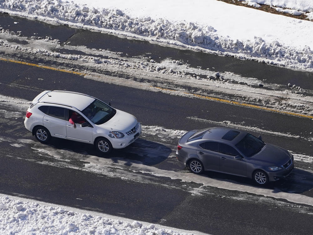 Stranded motorists wait for a tow on Interstate 95 on Tuesday in Ladysmith, Va. About 48 miles of the interstate were closed due to ice and snow.