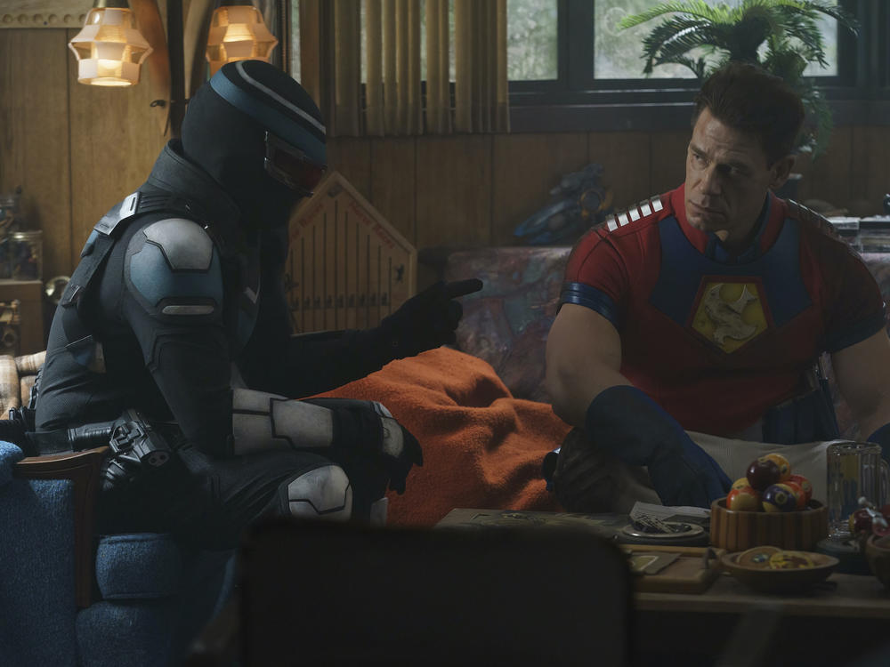 L to R: Vigilante (Freddie Stroma) and Peacemaker (John Cena) play mercs who are jerks in <em>Peacemaker</em>.