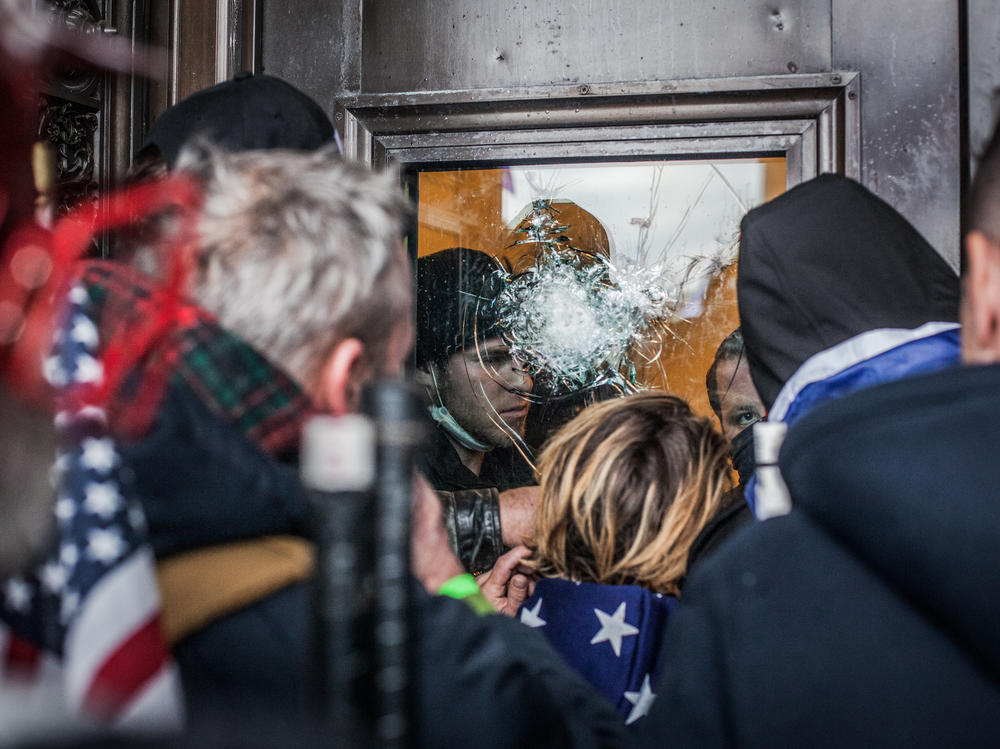 Capitol Police officers try to hold off the crowds from inside the U.S. Capitol on Jan. 6, 2021. At the end of the day, windows and doors were smashed, trash littered the building and several people were dead.