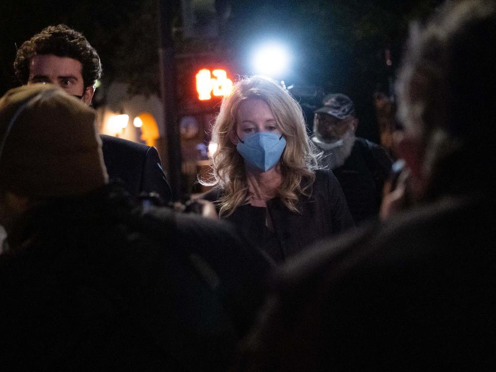 Elizabeth Holmes and partner Billy Evans walk outside the federal court in San Jose, California on January 3.