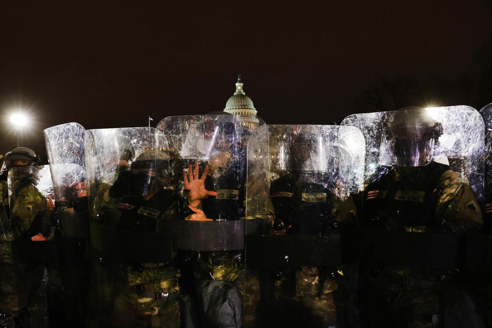 Members of the National Guard and the Washington, D.C., police keep a group of demonstrators away from the U.S. Capitol on Jan. 6, 2021.