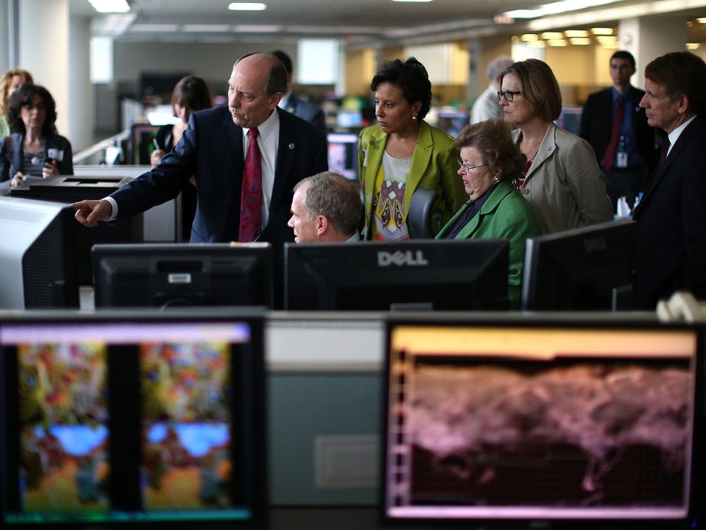 In this 2013 photo, National Weather Service Director Louis Uccellini (left) gives a tour of NOAA's Center for Weather and Climate Prediction to Commerce Secretary Penny Pritzker (second from left), Maryland Senator Barbara Mikulski (D-MD) (third from right), NOAA Acting Administrator Kathryn Sullivan (second from right), and Bryan Norcross (right) of the Weather Channel.