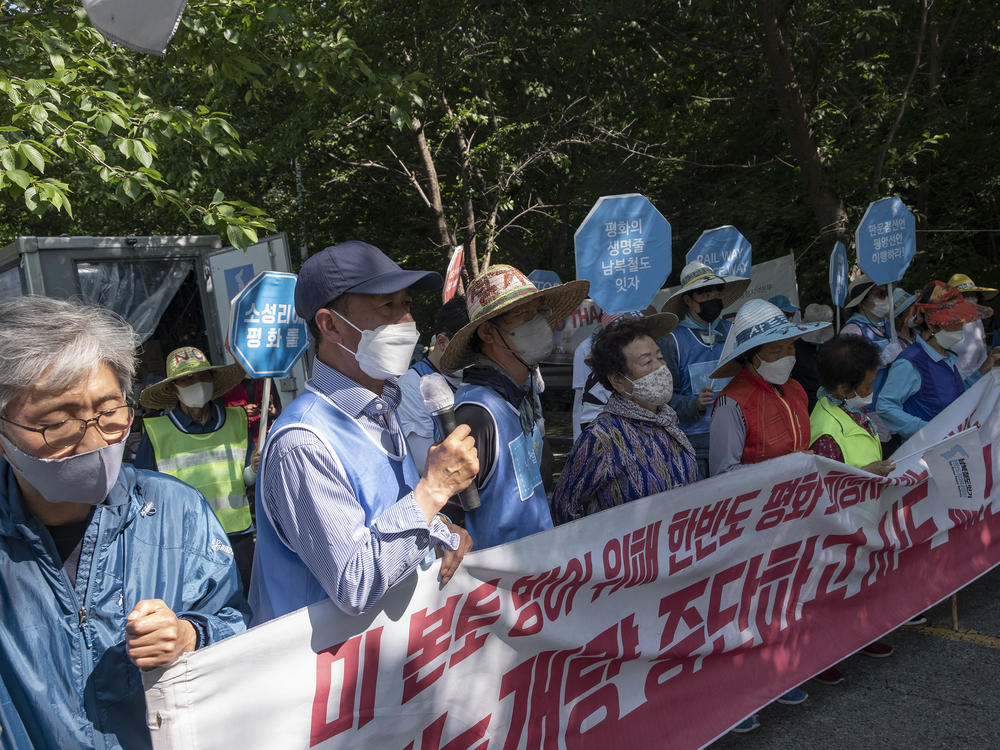 Activists demonstrate against a U.S. missile defense system installed in Seongju county, South Korea, since 2017. Protesters stand near the entrance of the base, the site of a former golf course.