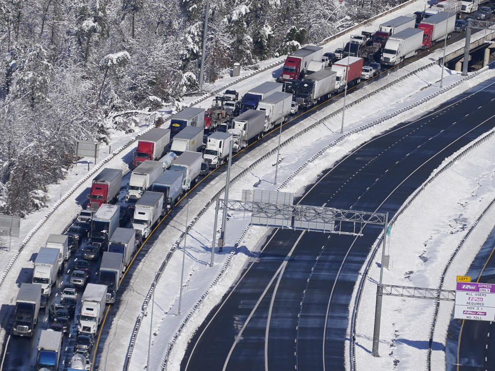 Cars and trucks are stranded on sections of Interstate 95 Tuesday Jan. 4, 2022, near Quantico, Va. Close to 48 miles of the Interstate was closed due to ice and snow.