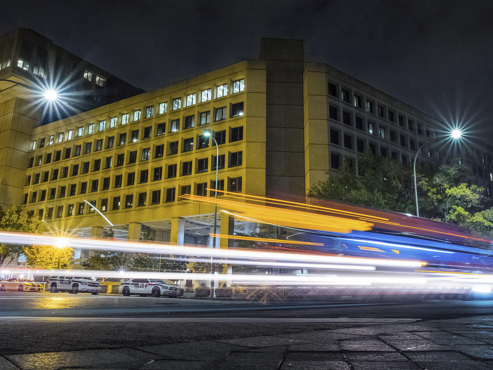 In this Nov. 1, 2017, file photo traffic along Pennsylvania Avenue in Washington streaks past the Federal Bureau of Investigation headquarters building.