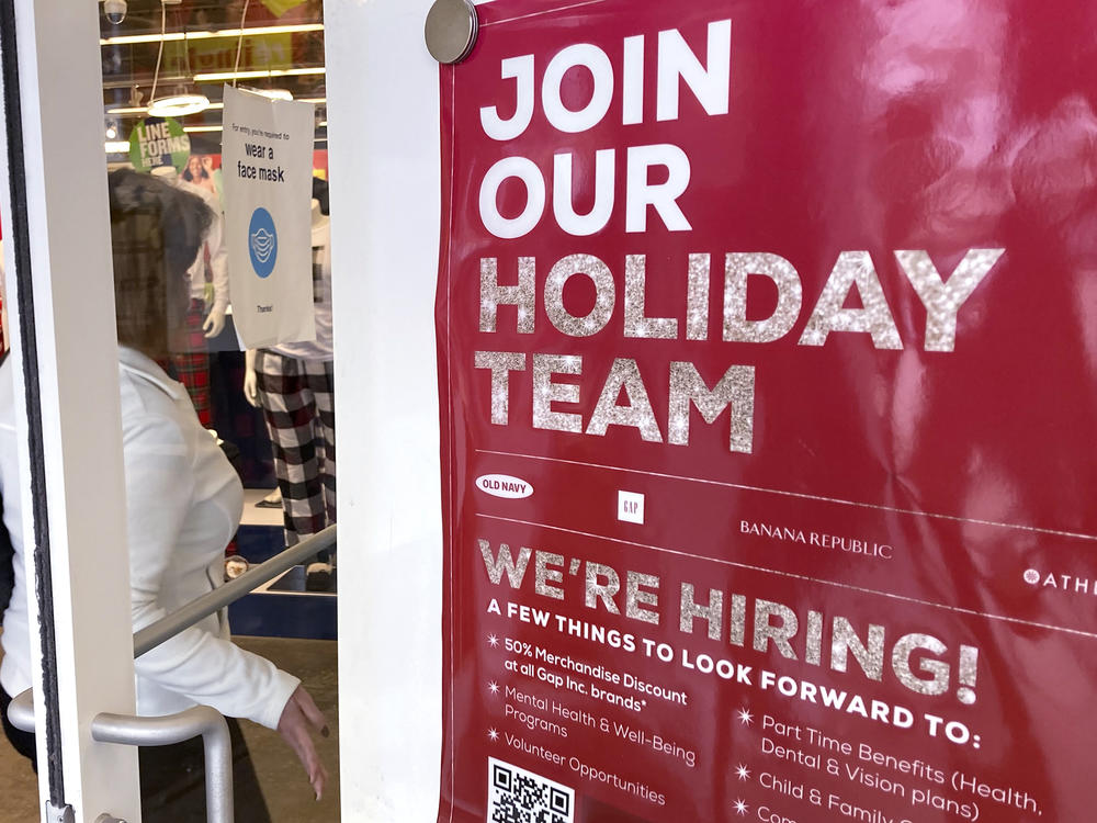 A sign hiring workers for the holidays is displayed at a retail store in Vernon Hills, Ill.,on Nov. 13, 2021.