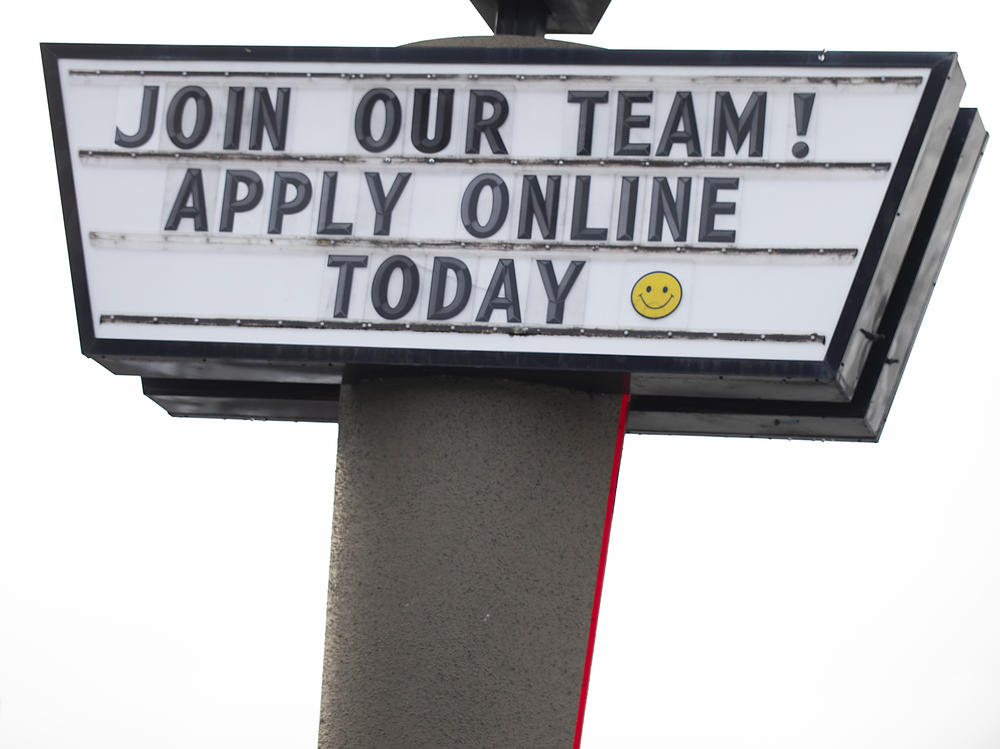 A sign seeking workers is displayed at a fast food restaurant in Portland, Ore., on Dec. 27, 2021.