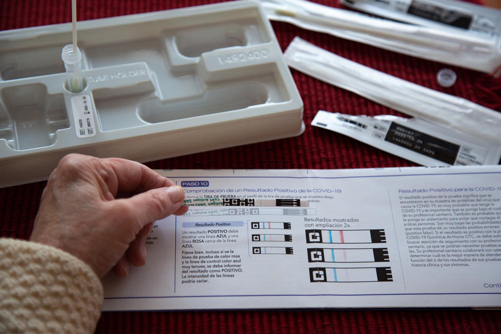 A home tester checks out the result on a test strip.