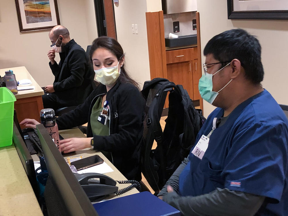 Mary Venus, a nurse from the Philippines, and Pae Junthanam, a nurse from Thailand, talk during their shift at Billings Clinic in Billings, Mont.