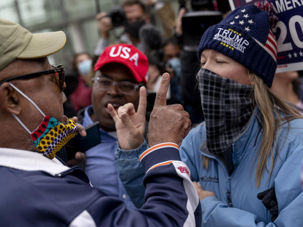 Trump supporters at right argue with a counterprotester in Detroit on Nov. 5, 2020.