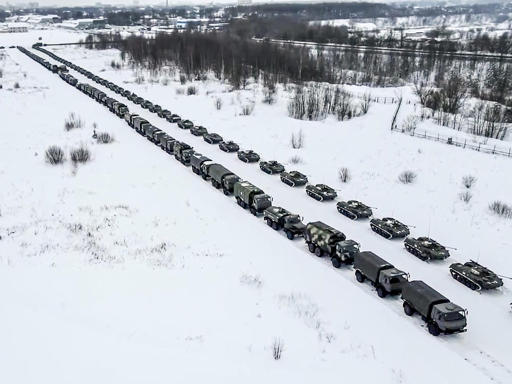 Russian military vehicles are parked waiting to be uploaded on planes at an airfield in Russia on Friday. Over 70 cargo planes are being deployed in Russia's peacekeeping mission in Kazakhstan, according to the Russian Defense Ministry's chief spokesman.