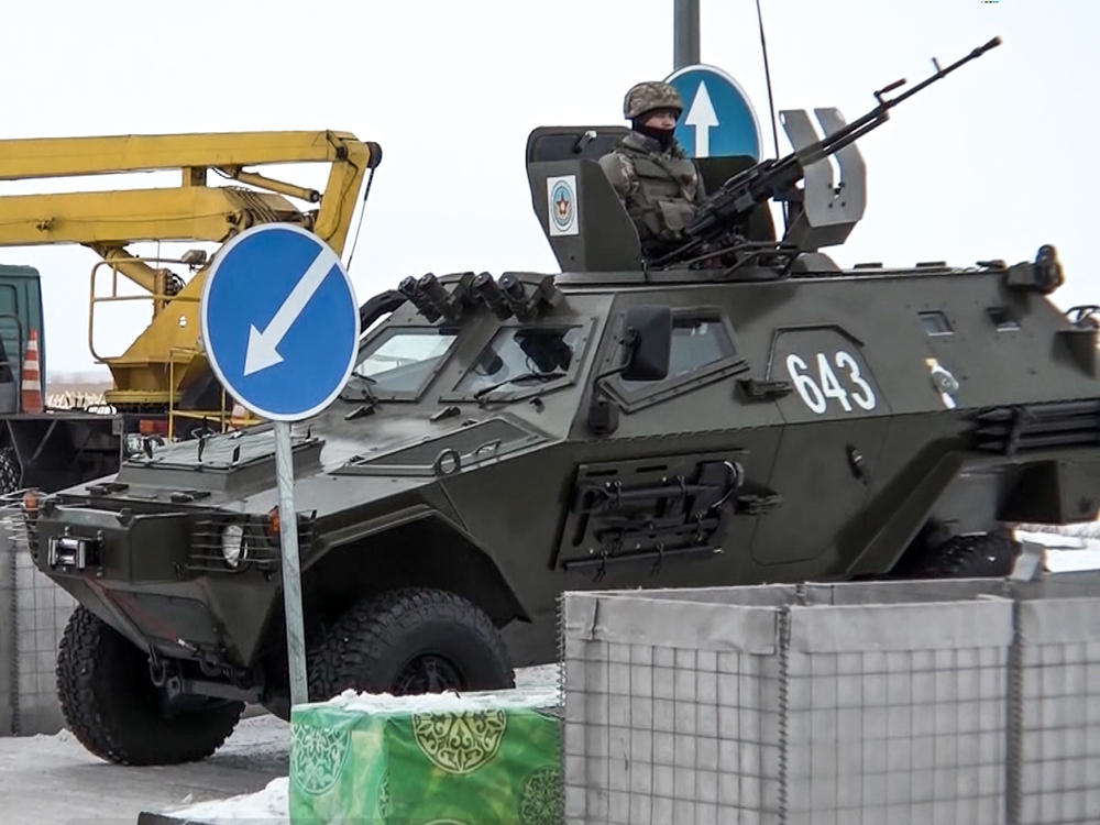 A Kazakh soldier stands next to a military vehicle at a check point in Kazakhstan on Friday.