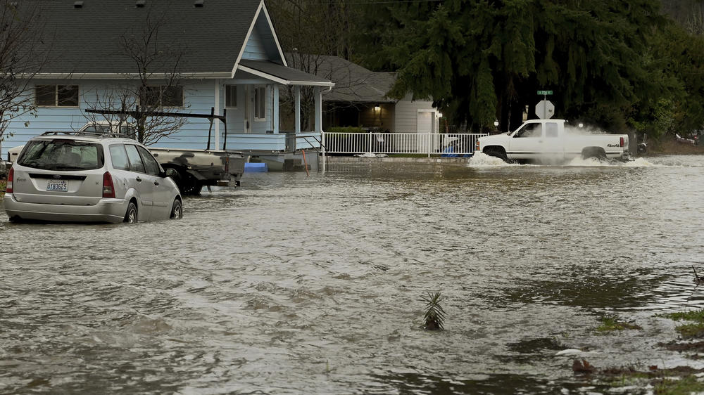 Rising water from the nearby Skookumchuck River begins to inundate several streets in the town of Bucoda, Wash., Friday, as area rivers and snow runoff begin to accelerate flooding in the south sound.