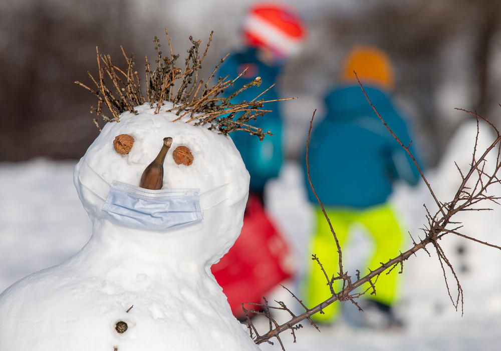 This German snowman wears a protective mask over its banana nose and mouth, but experts say the risk of catching COVID outdoors is slim.