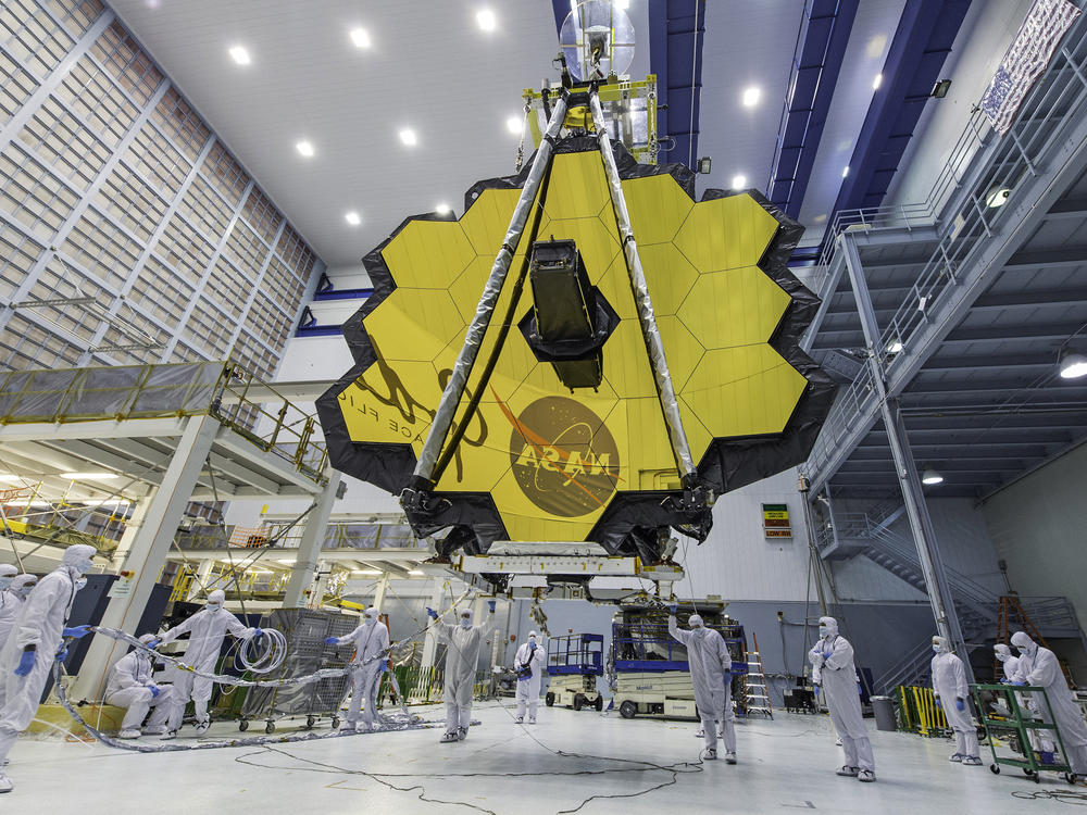 Technicians lift the mirror of the James Webb Space Telescope using a crane at the Goddard Space Flight Center in Greenbelt, Md., in April 2017. On Saturday, the telescope completed its final deployment in space.