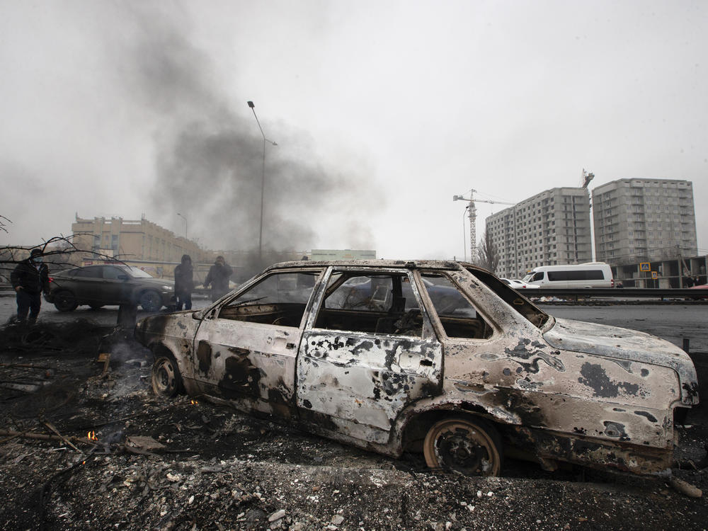 A car, which was burned after clashes, is seen on a street in Almaty, Kazakhstan, on Friday.