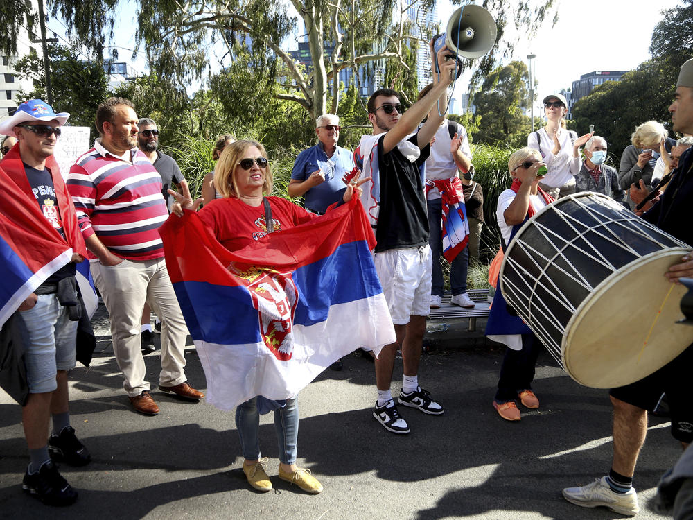 Protesters and fans of Novak Djokovic gather outside the Park Hotel, used as an immigration detention hotel where Djokovic is confined in Melbourne, Australia, on Saturday.