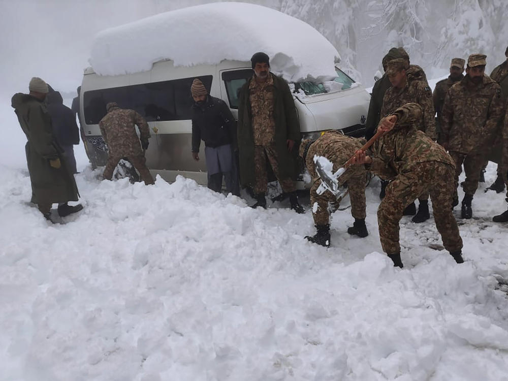 Army troops take part in a rescue operation in a heavy snowfall-hit area in Murree.