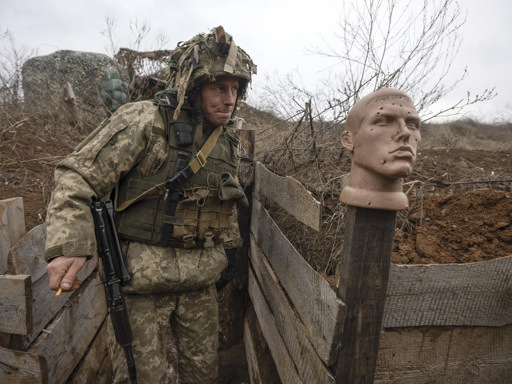 A Ukrainian soldier walks in a trench at the line of separation from pro-Russian rebels in the Donetsk region of Ukraine on Sunday.