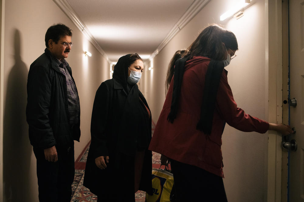 Kamila Noori enters the apartment where she will live with her husband Mohibullah Mohib, at left, and two of their daughters.