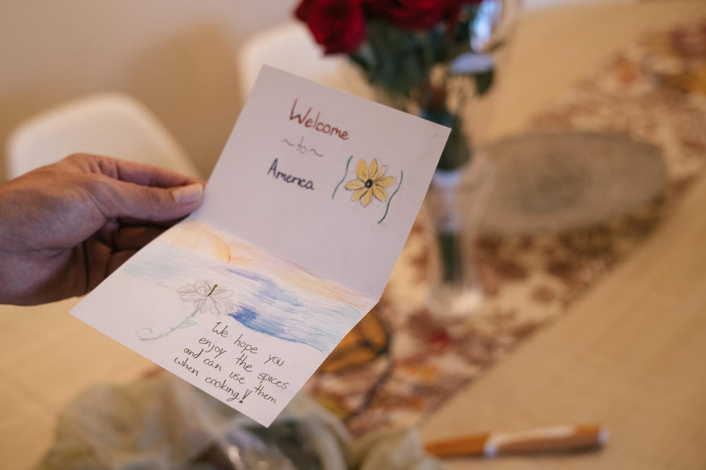 Mohibullah Mohib holds a note he received from an American group that supplied his family with groceries in their new home.