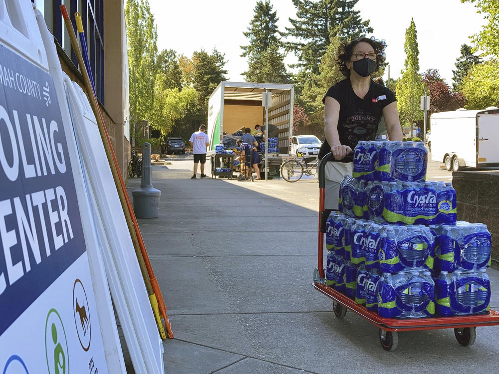 A volunteer helps set up snacks at a cooling center established  to help vulnerable residents ride out the second dangerous heat wave to grip the Pacific Northwest last summer, on Aug. 11, 2021.
