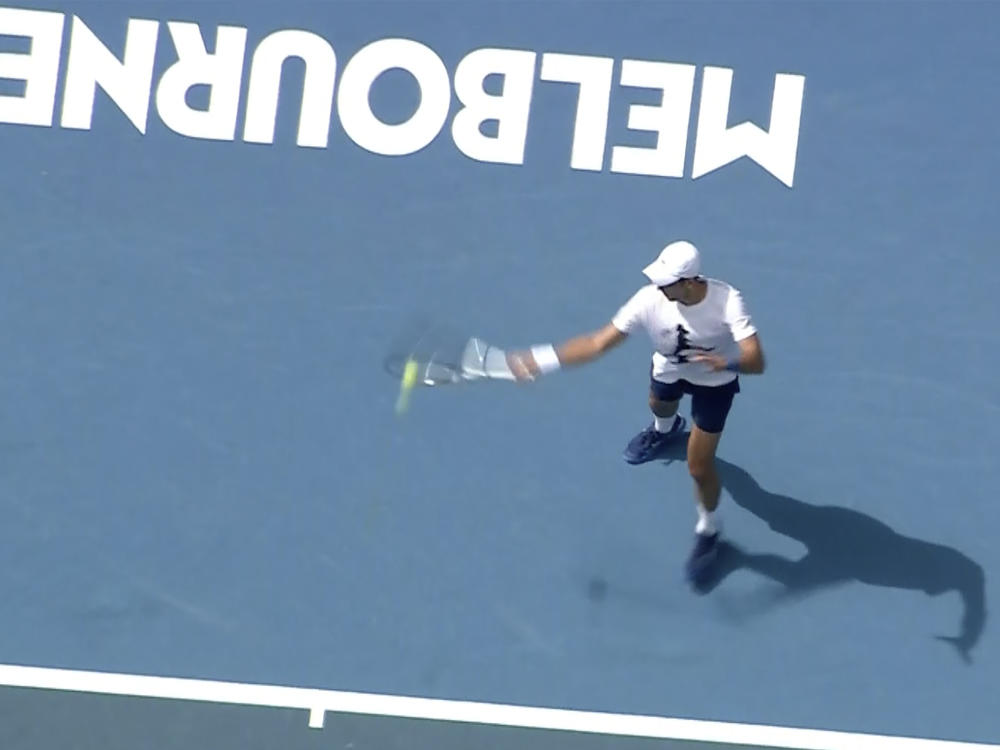 In this image taken from aerial video footage, tennis star Novak Djokovic practices on the tennis court on Tuesday in Melbourne, Australia.