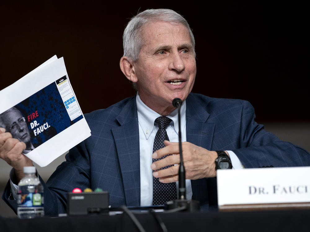 Dr. Anthony Fauci, director of the National Institute of Allergy and Infectious Diseases and chief medical adviser to the president, holds up printouts from Sen. Rand Paul's reelection campaign website.