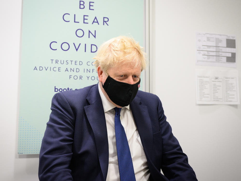 A 2020 email from British Prime Minister Boris Johnson's private secretary shows that 10 Downing Street hosted a private party, at a time when the country was under lockdown. Johnson is seen here visiting a pharmacy in his home constituency of Uxbridge, England, on Monday.