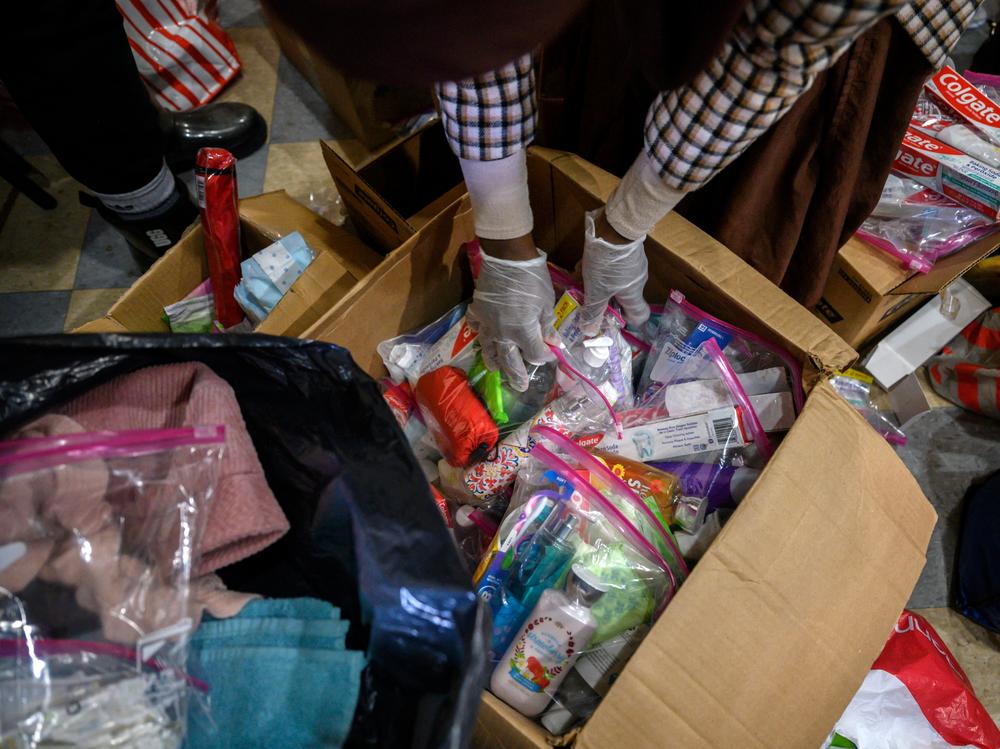 Volunteers prepare donations of clothes, food and other items for people displaced by a fire at an apartment building nearby in the Bronx.