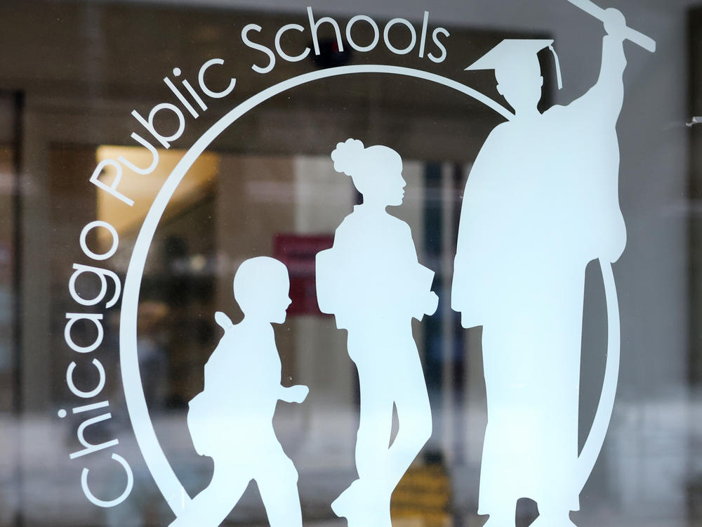 A sign on the front of the headquarters for Chicago Public Schools. Class is set to resume Wednesday after days of canceled lessons.