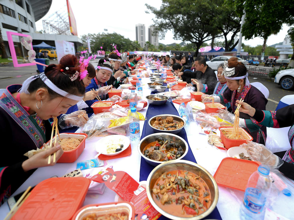 Above: locals in Liuzhou feast on their regional specialty of snail noodles. The novelty of the dish has made it a viral sensation in China during the pandemic.