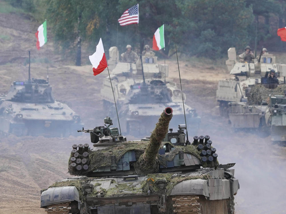 Military vehicles and tanks of Poland, Italy, Canada and United States roll during the NATO military exercises ''Namejs 2021'' at a training ground in Kadaga, Latvia, Sept. 13, 2021.