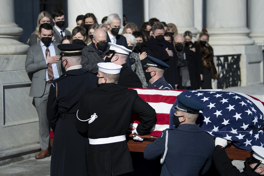 Family members including Josh Reid, Rory Reid and Landra Gould watch as a U.S. Joint Forces bearer team carries the casket of former Senate Majority Leader Harry Reid into the U.S. Capitol.