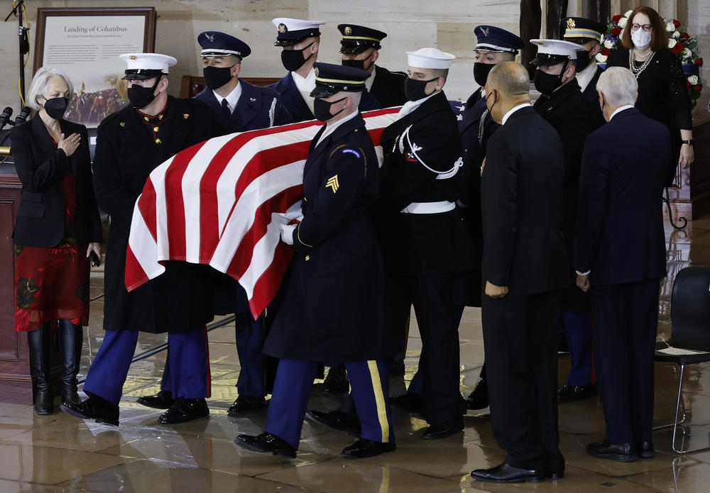 A U.S. Joint Forces bearer team carries the casket of former Senate Majority Leader Harry Reid into the Rotunda of the  Capitol.