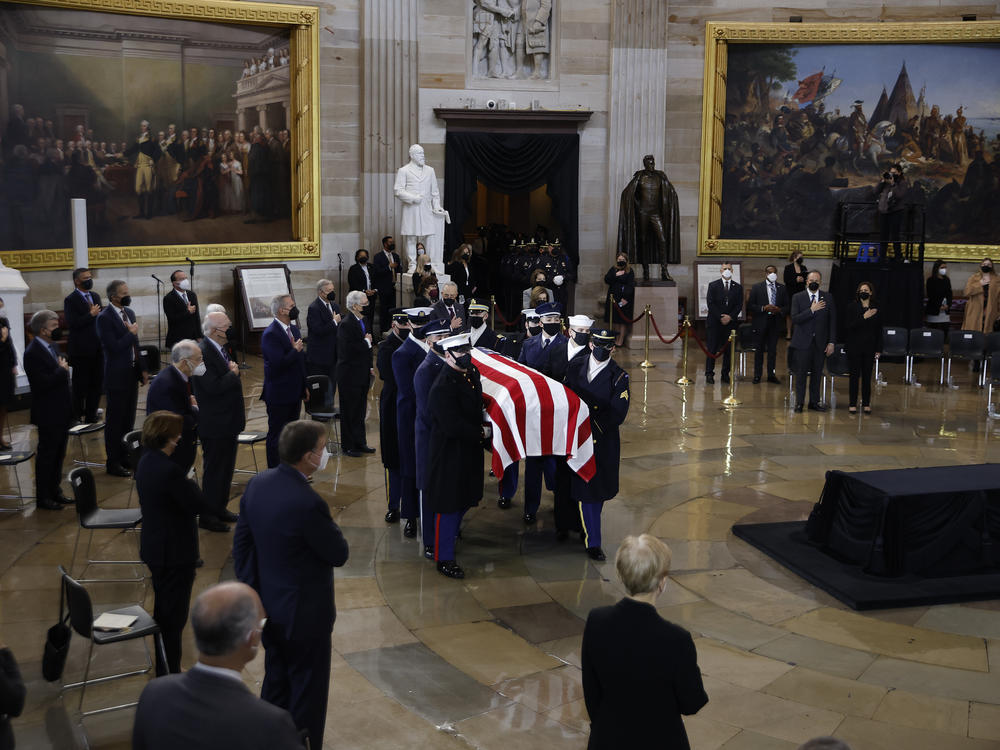 A U.S. Joint Forces bearer team carries the flag-draped casket of former Senate Majority Leader Harry Reid, D-Nev., into the Rotunda of the U.S. Capitol where he will lie in state on Wednesday.