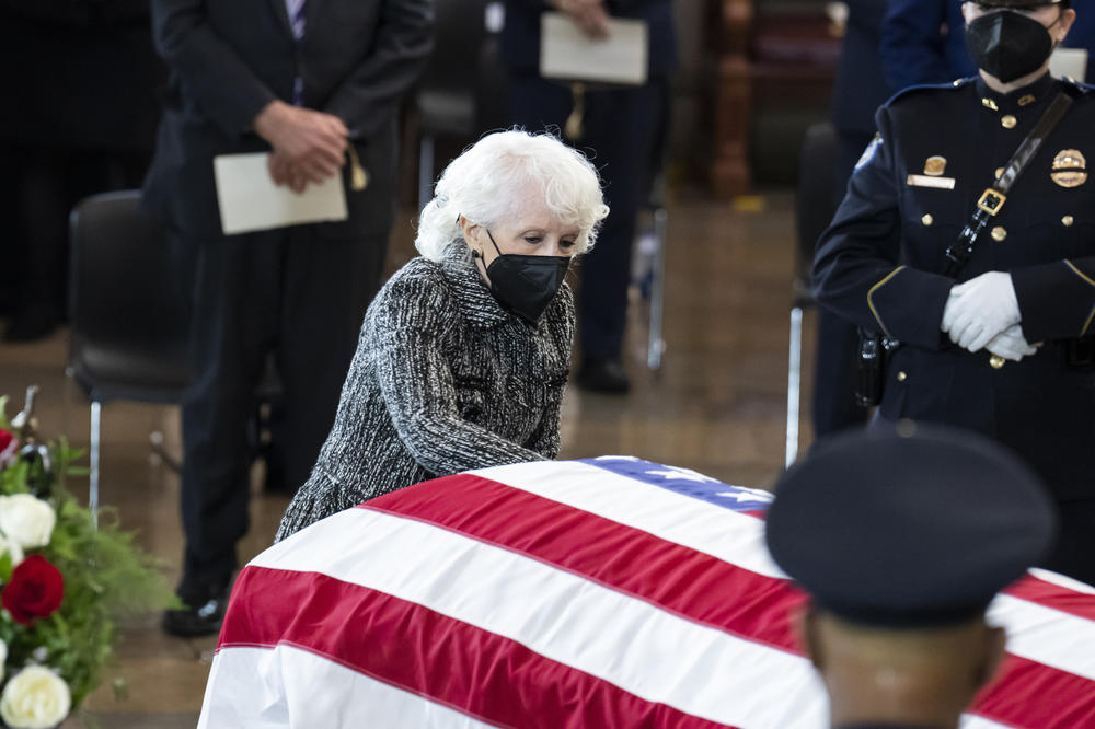 Landra Gould, widow of former Senate Majority Leader Harry Reid, pays her respects at his casket during a memorial service in the Capitol Rotunda.