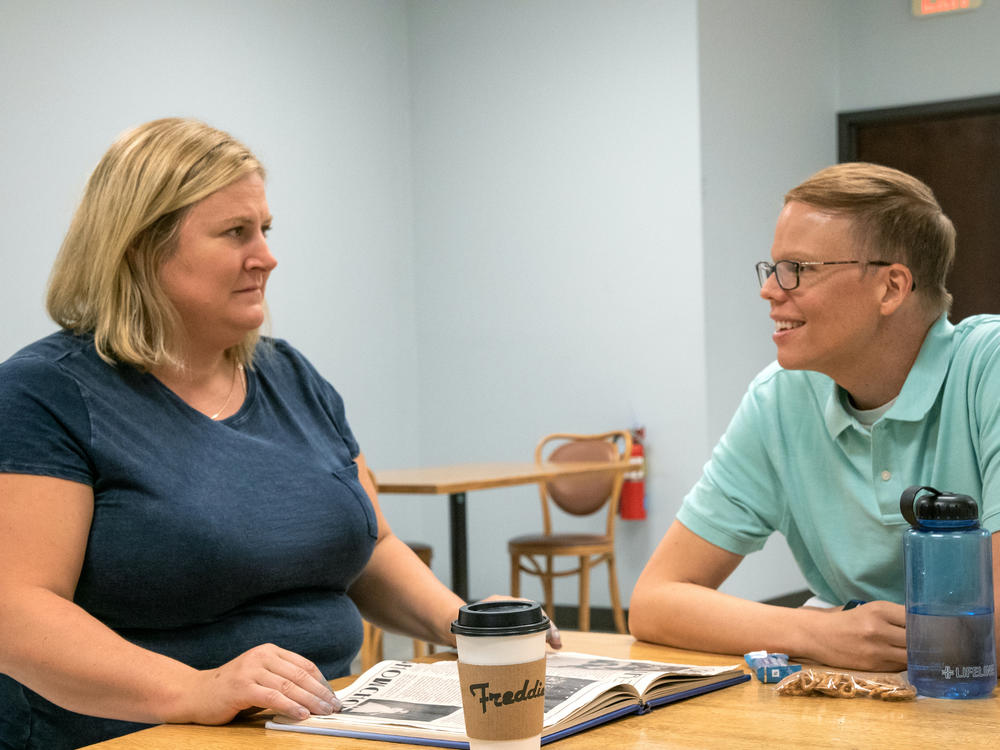 Sam (Bridget Everett) and Joel (Jeff Hiller) bond over student essays in <em>Somebody Somewhere</em>.
