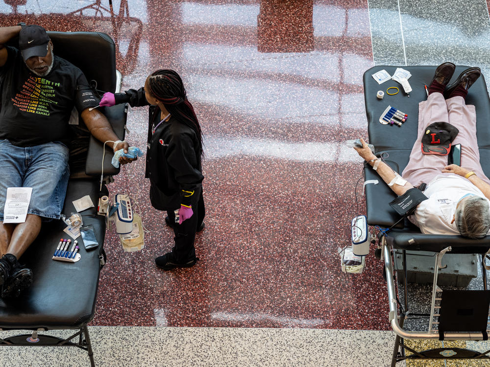 A phlebotomist tends to a blood donor during the Starts, Stripes, and Pints blood drive event in Louisville, Ky., in July. Rising numbers of organ transplants, trauma cases, and elective surgeries postponed by the COVID-19 pandemic have caused an increase in the need for blood products.