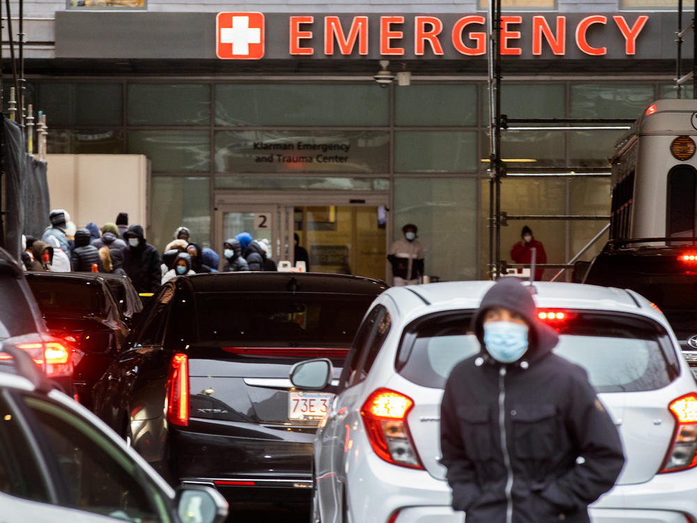People and cars line up outside Boston Medical Center near the emergency room, where COVID-19 testing was taking place, on Jan. 3.