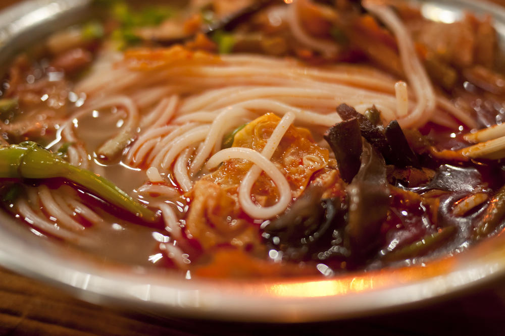 A Chinese street stall serves up a bowl of snail noodles.