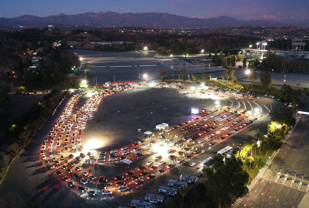Cars line up at a COVID-19 testing site at Dodger Stadium in Los Angeles, California ahead of New Year's Eve. Many free testing sites have been overwhelmed by demand.