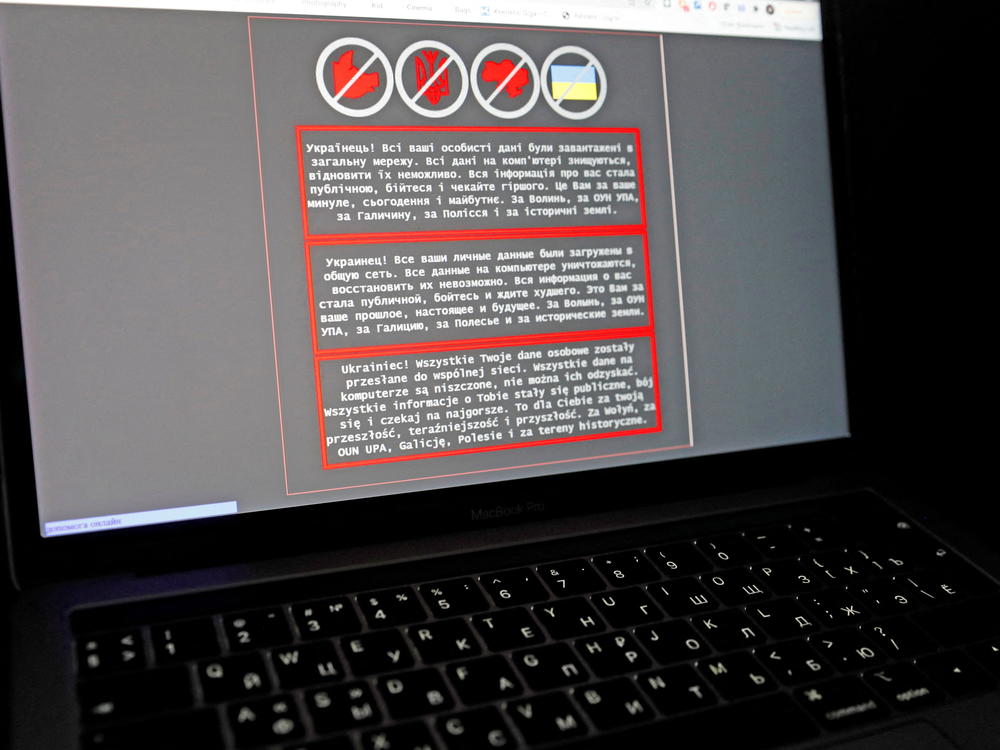 A laptop screen displays a warning message in Ukrainian, Russian and Polish that appeared on the official website of the Ministry of Foreign Affairs of Ukraine after a massive cyberattack on Friday.