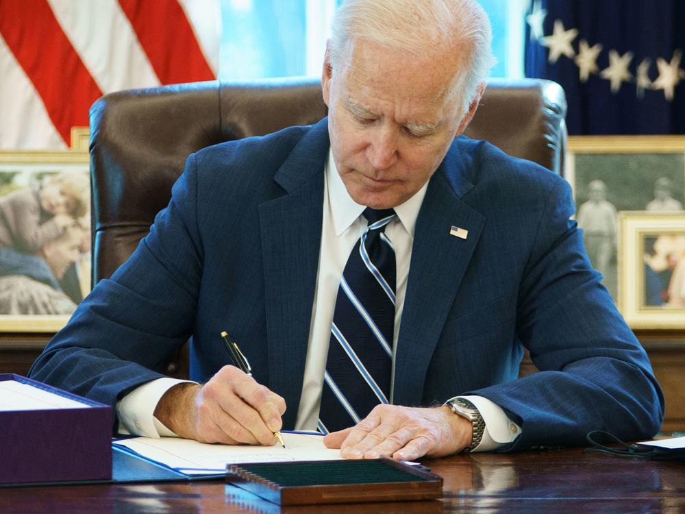 President Biden signs the American Rescue Plan on March 11, 2021, in the Oval Office of the White House in Washington, D.C. The bill was one of several pieces of legislations passed by Congress to provide help to Americans during the pandemic.