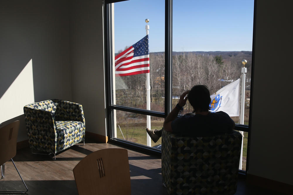 A person in recovery for drug addiction looks out from a substance abuse treatment center in Westborough, Mass.